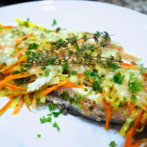 A plate of garnished Easy to make Riesling Poached Trout.