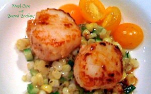 fresh corn with seared scallops on a plate