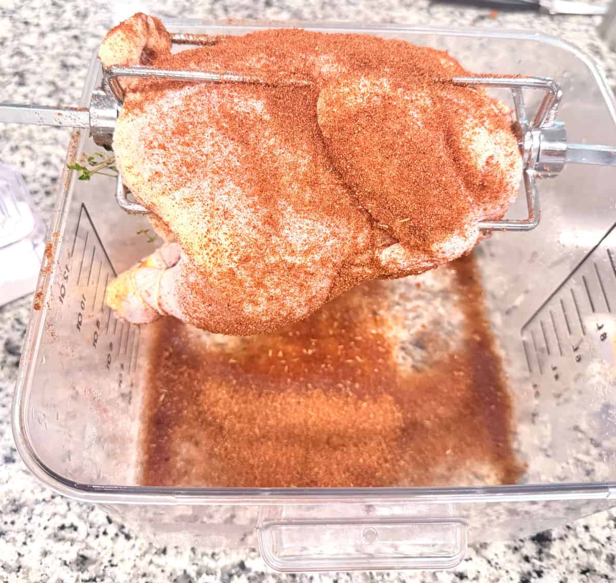 A fully seasoned chicken ready to cook.