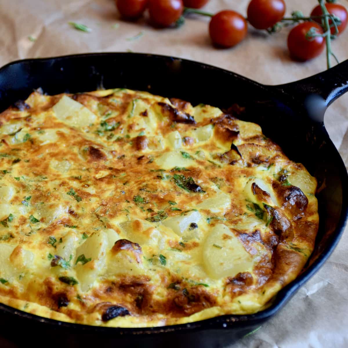 A cast iron pan holds a nicely browned Spanish Tortilla.