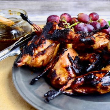 Grilled Quail on a pewter platter.