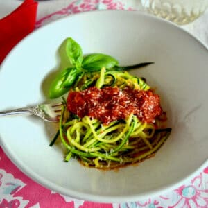A bowl of zucchini spaghetti (zoodles) with fresh tomato sauce.