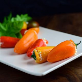 Cheesy Grilled Stuffed Mini Peppers on a white plate.