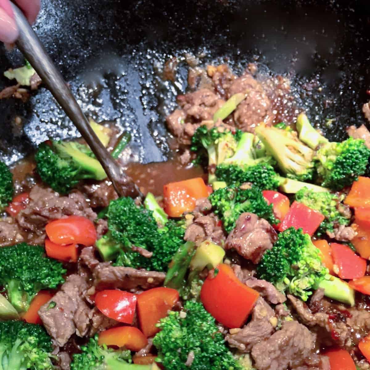 Beef Broccoli Stir-Fry in a wok being tossed.