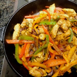 A hot cast-iron skilled holds perfect homemade chicken fajitas.