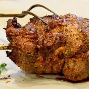 A whole cooked leg of lamb that has been cooked over the rotisserie.