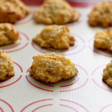 Cheddar Black Pepper Drop Biscuits on a silicon mat.