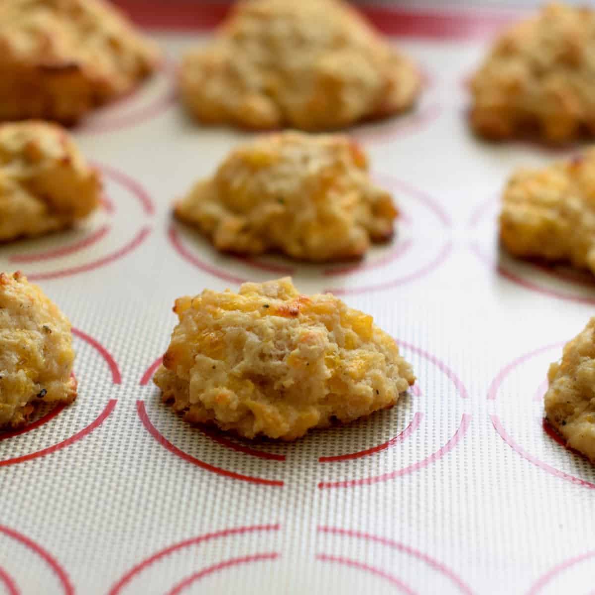 Cheddar Black Pepper Drop Biscuits on a silicon mat.