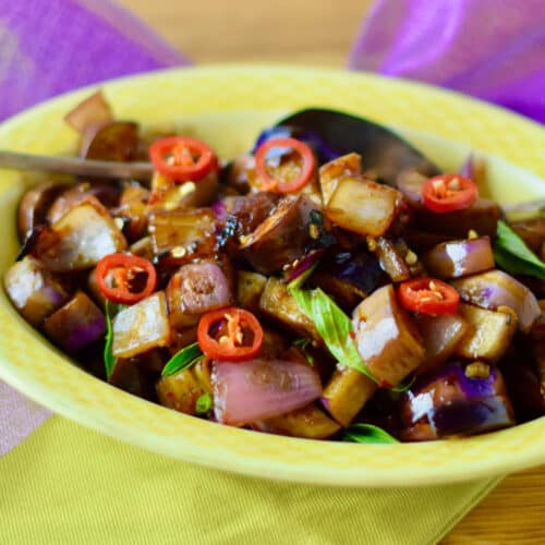 Quick Spicy Thai Style Eggplant in a yellow serving dish.