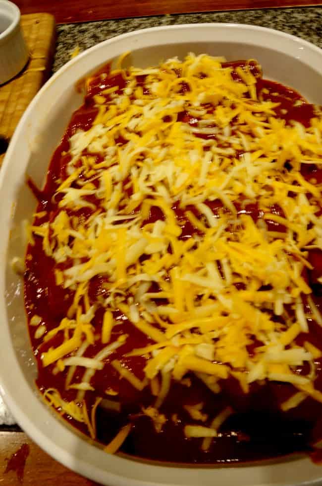 fully loaded cheese enchilada in a casserole dish ready to cook