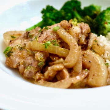 A plate with Braised Lemon Fennel Chicken Thighs, rice and brocolli.