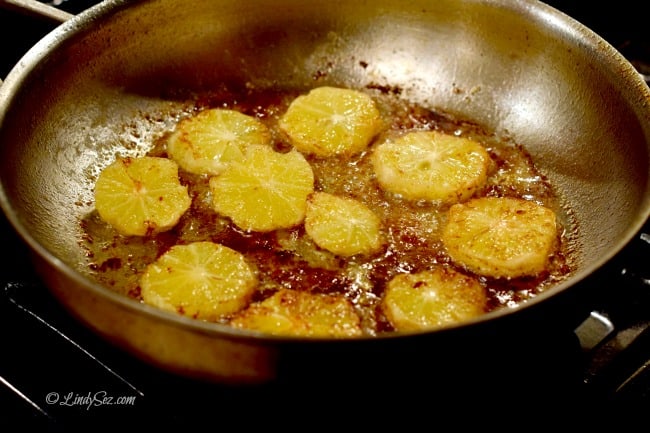 Frying lemons in a pan for Braised Lemon Fennel Chicken Thighs