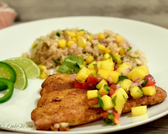 Simple Panfried Curry Snapper with Mango Salsa on a white plate with rice