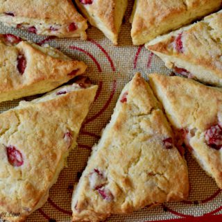 Freshly baked strawberry cream scones on a silpat.
