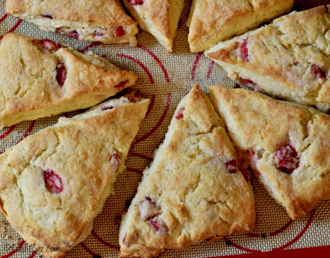 Freshly baked strawberry cream scones on a silpat.