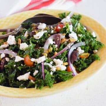 Massaged Kale Greek Salad in a yellow bowl.