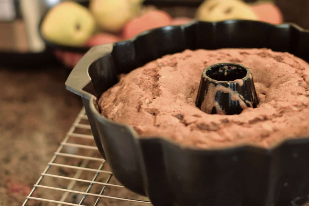 Apple Chunk Cake in a bundt pan with apples.