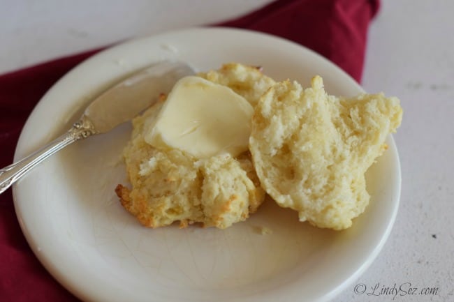 Tender Simple Homemade Buttermilk Drop Biscuits on a plate with a pat of butter.