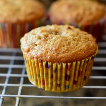 A tasty muffin cooling on a wire rack.
