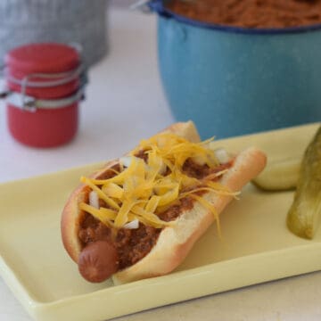 A hot dog dressed in chili sauce.