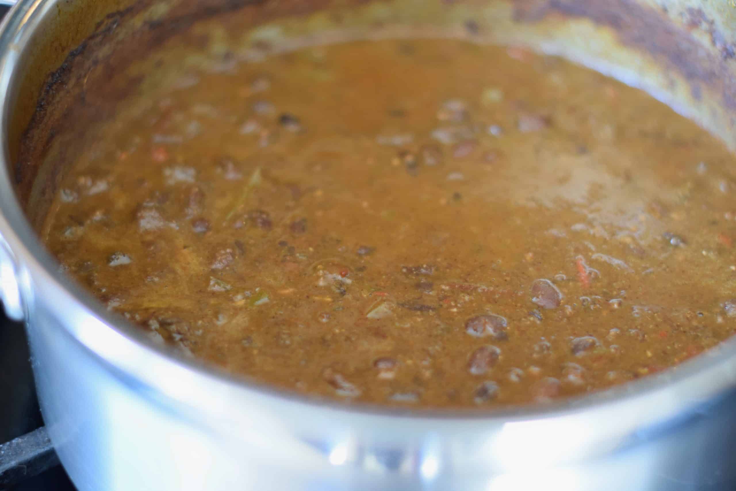 Spicy Black Beans with Chorizo cooking in a pot.