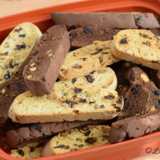 Chocolate Cherry with Pistachio Biscotti in a air tight orange container.