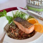 Earthy lentils sit under a nicely cook piece of crispy skinned salmon.