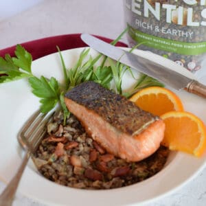 Earthy lentils sit under a nicely cook piece of crispy skinned salmon.