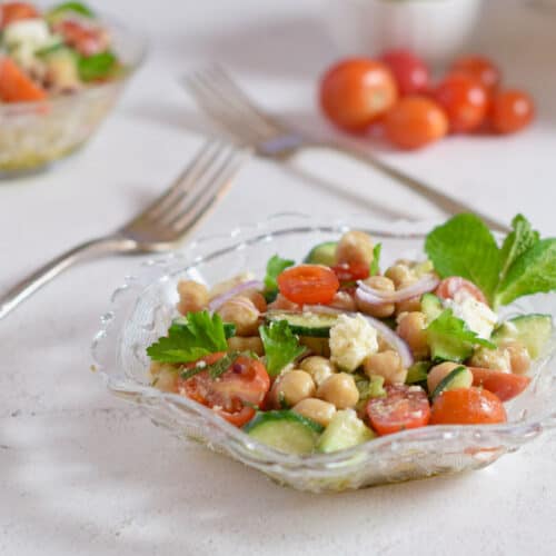 A glass dish filled with Chickpea salad with feta.