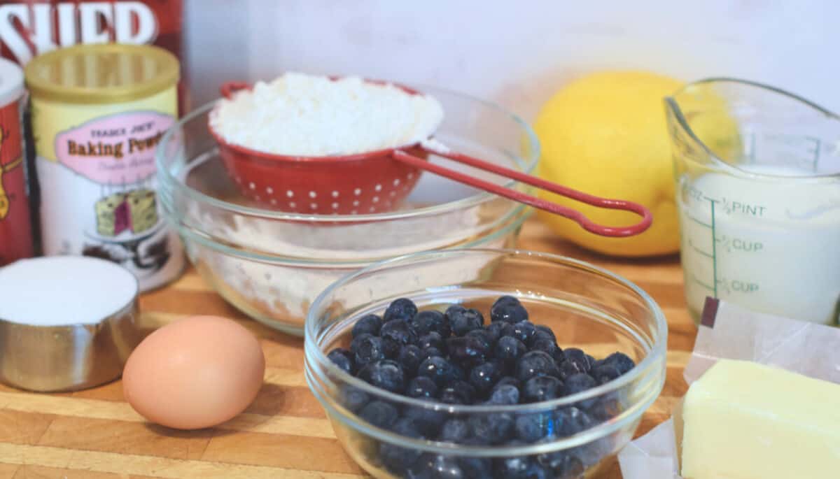 All of the ingredients needed to make blueberry muffins set out and ready.