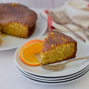 A plate of All in Orange cake with silverware.