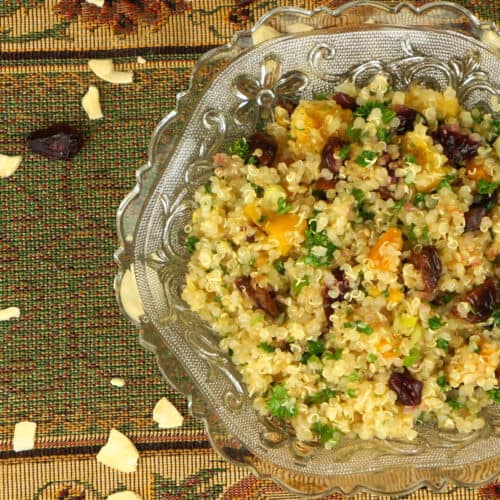 Quinoa Salad with Dried Fruits on a place mate with nuts and dried fruit.