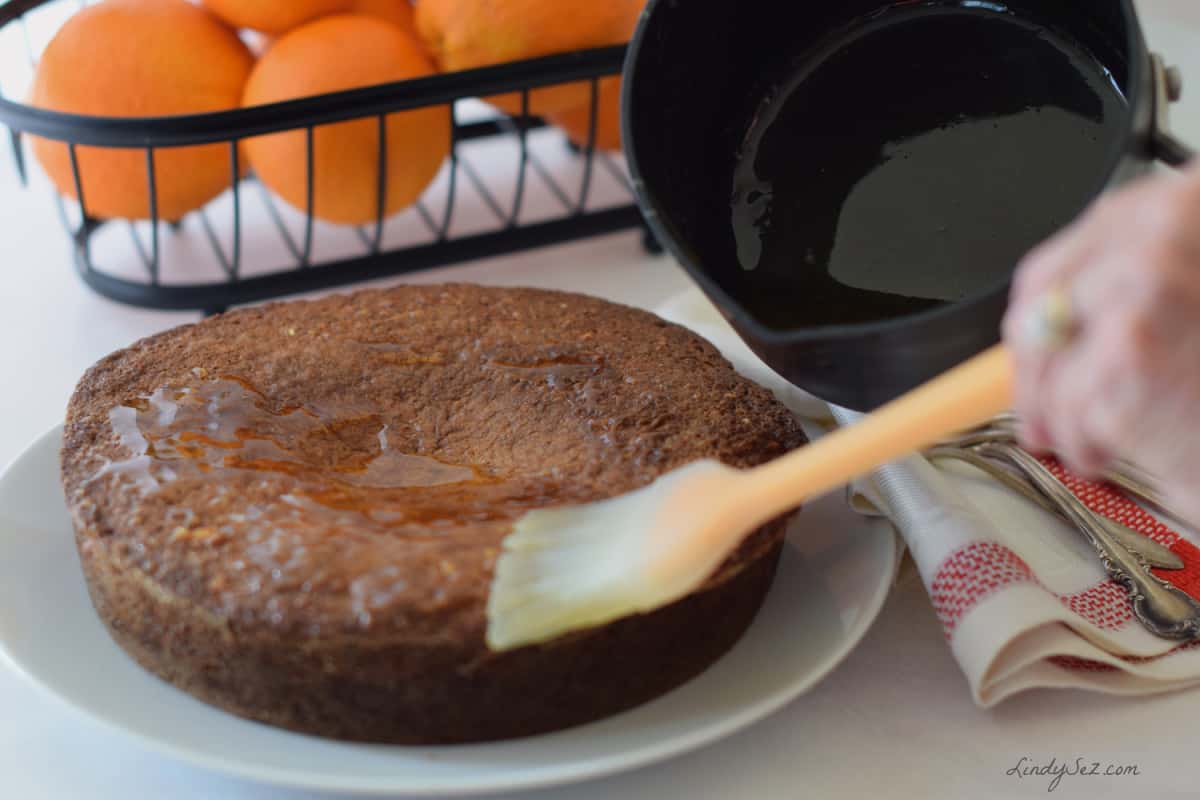 Glazing the all in orange cake with a brush. 
