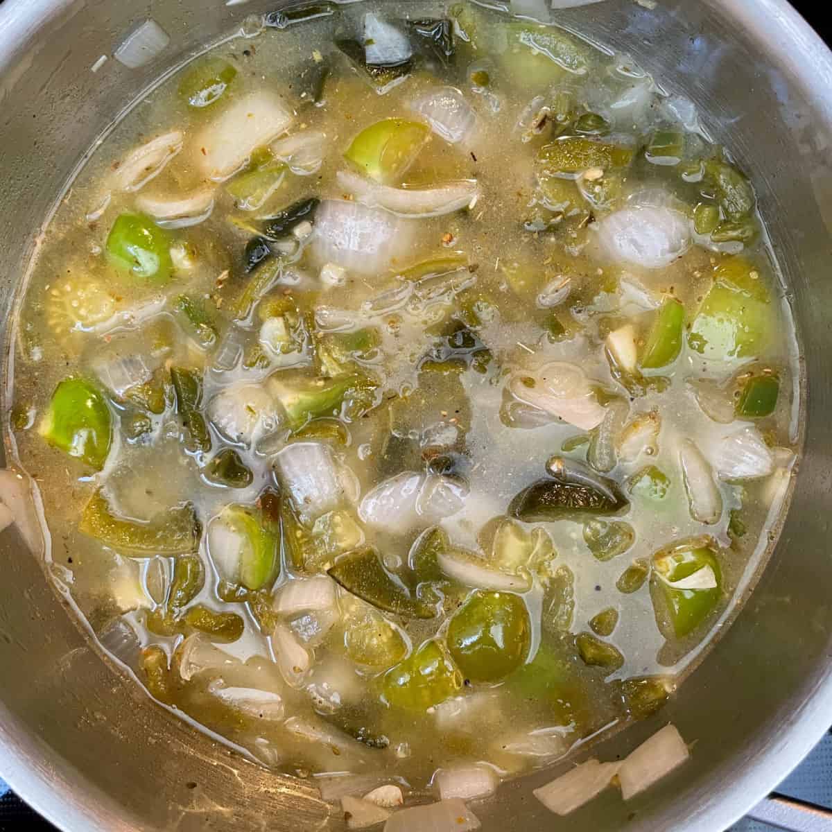 Green enchilada sauce on the stove ready to be blended.