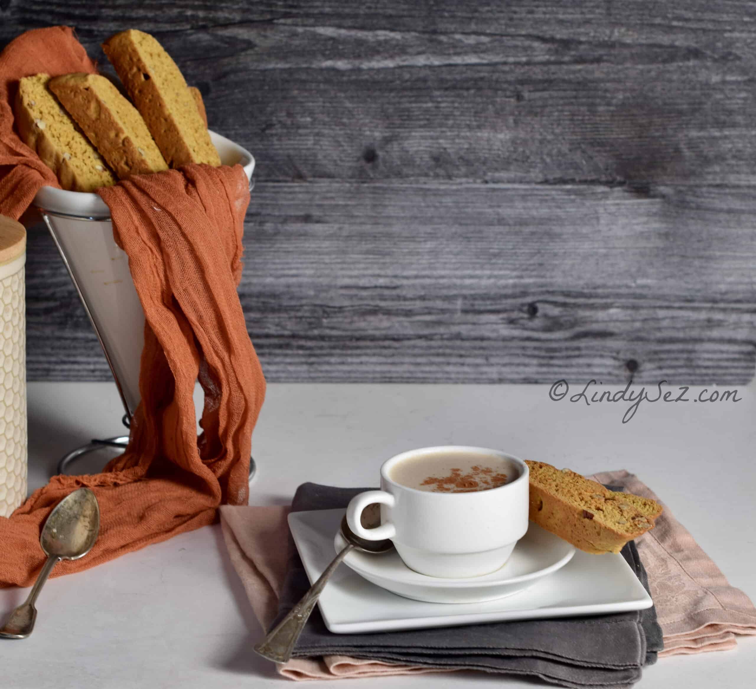 A plate of biscotti with a cup of coffee.