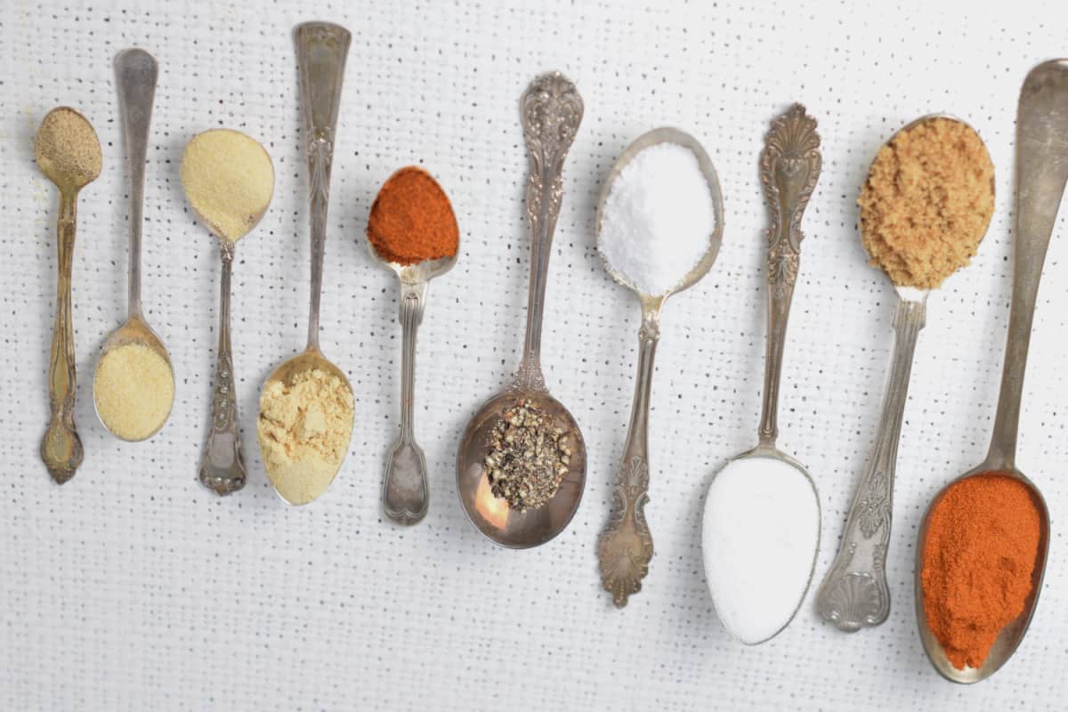 Spoons with rub ingredients .