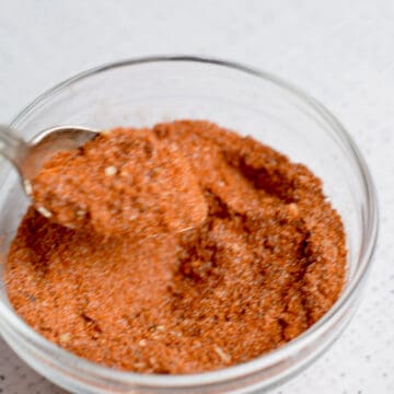 A spoon lifting out some sweet spicy rub.