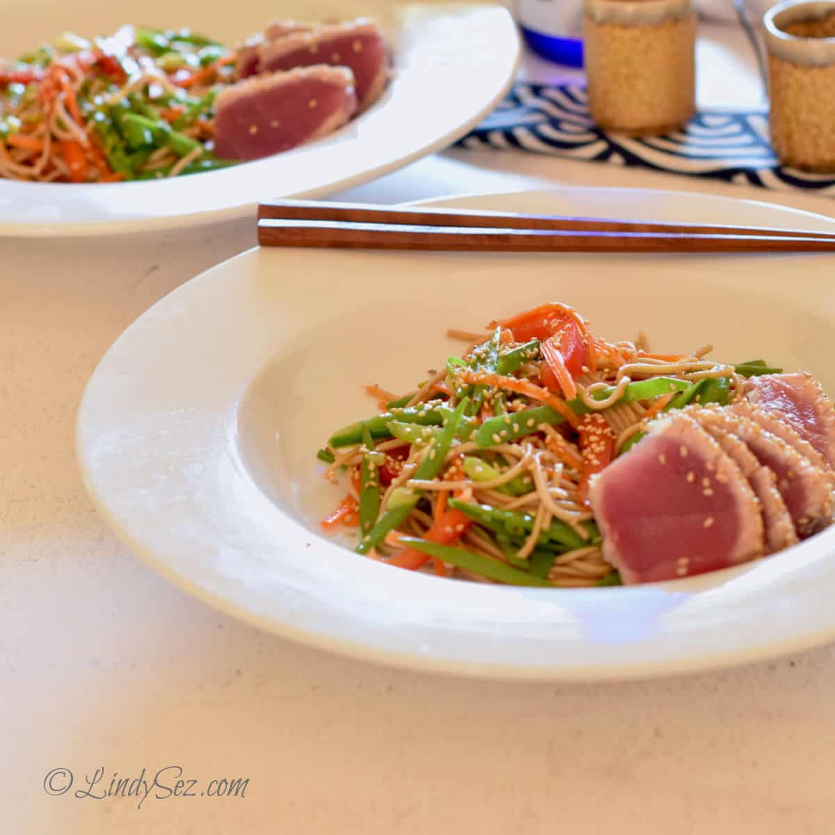 Seared Ahi Tuna with Soba Noodle salad with chop sticks and sake glassees.