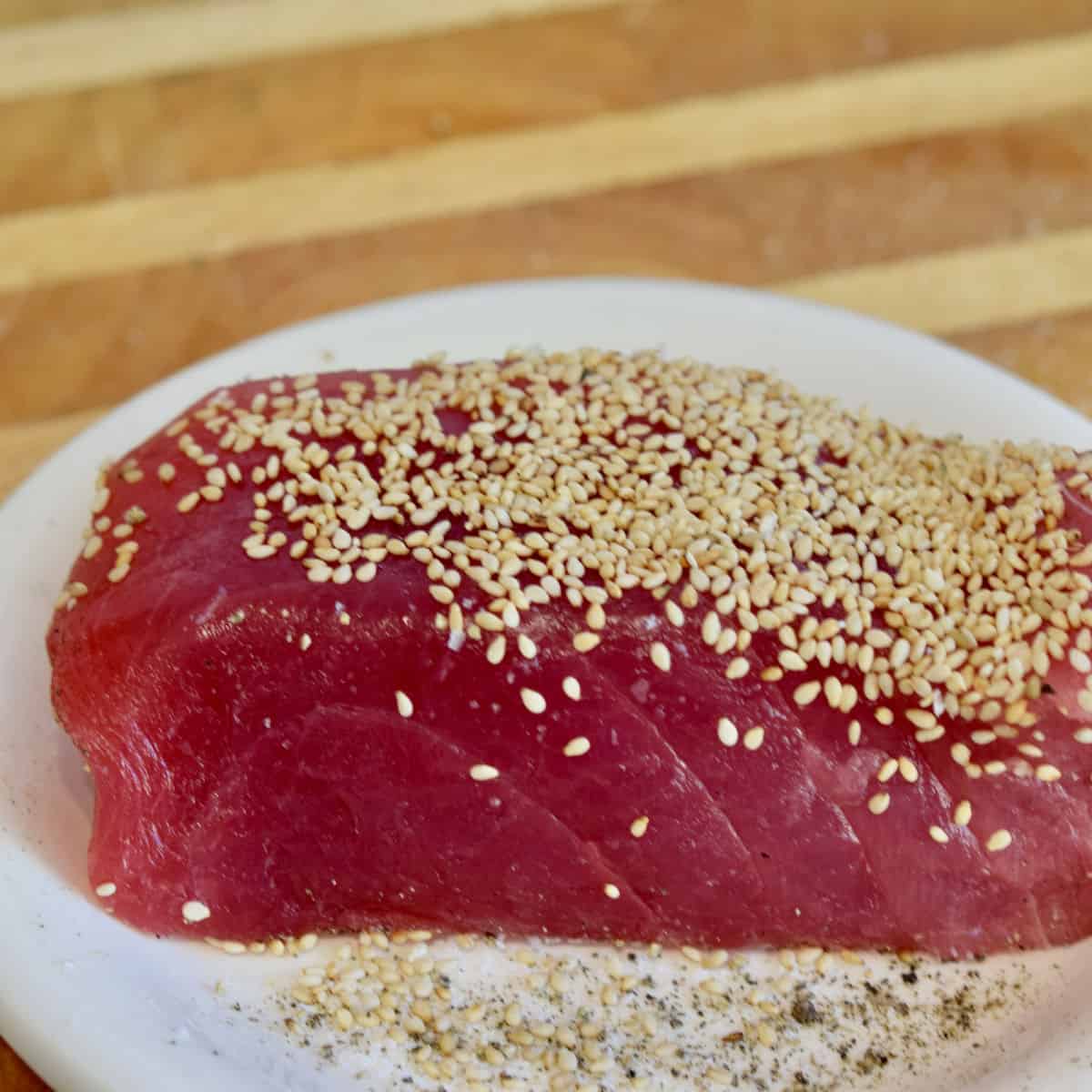 A piece of ahi tuna with sesame seeds on it.