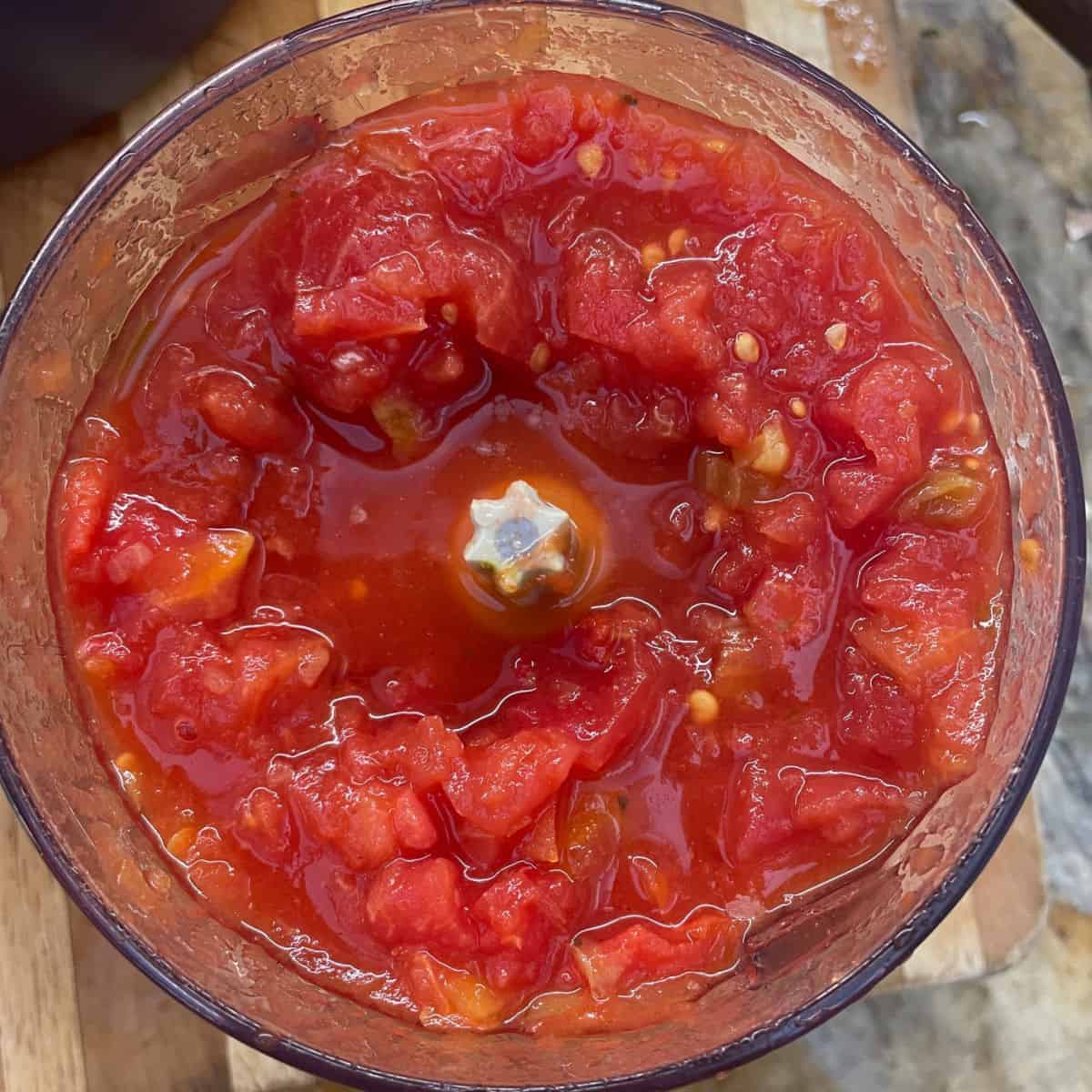 Rough chopping tomatoes in a food processor.