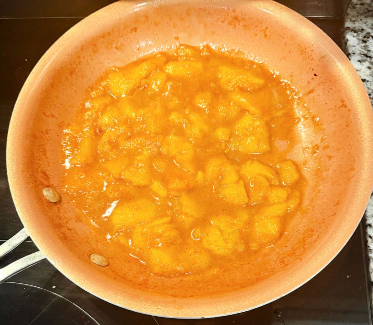 A skillet with peach compote being cooked.