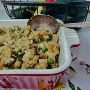 Cornbread Stuffing in a casserole dish with an antique spoon.