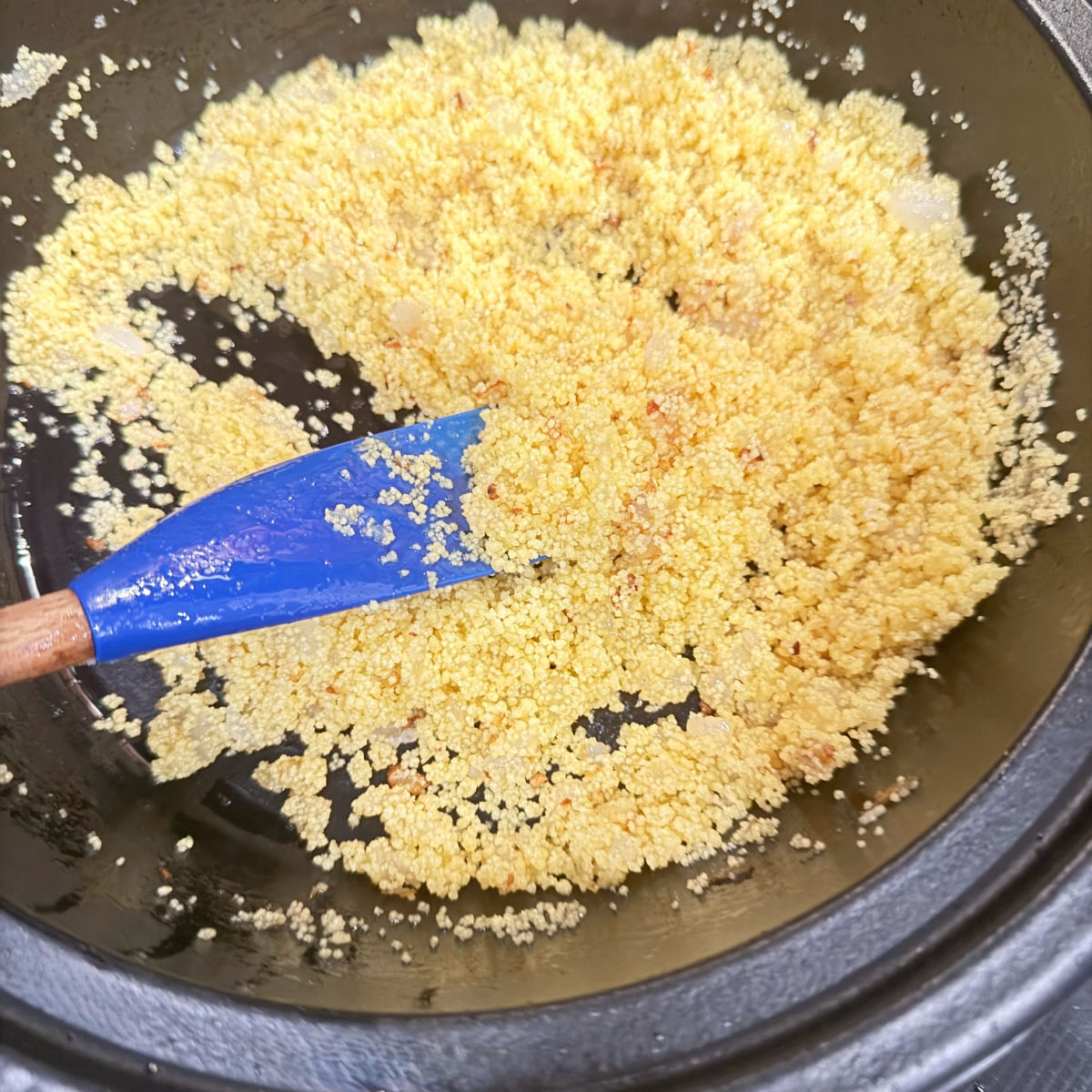Toasting couscous in a tagine.